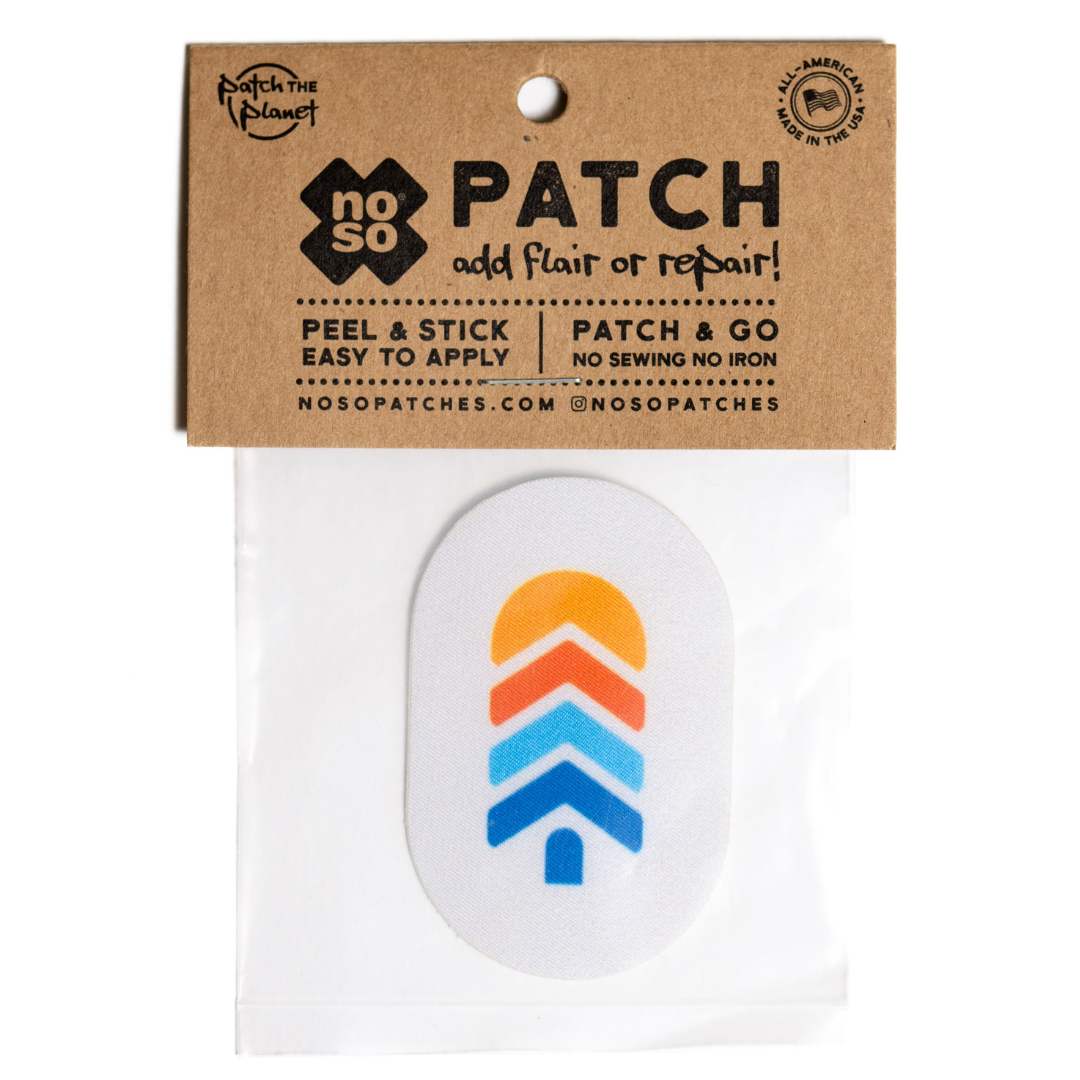 Snowy gray NOSO Gear Repair Patch with Town Hall logo shown in retail packaging with peel-and-stick instructions for quick and easy gear repairs.