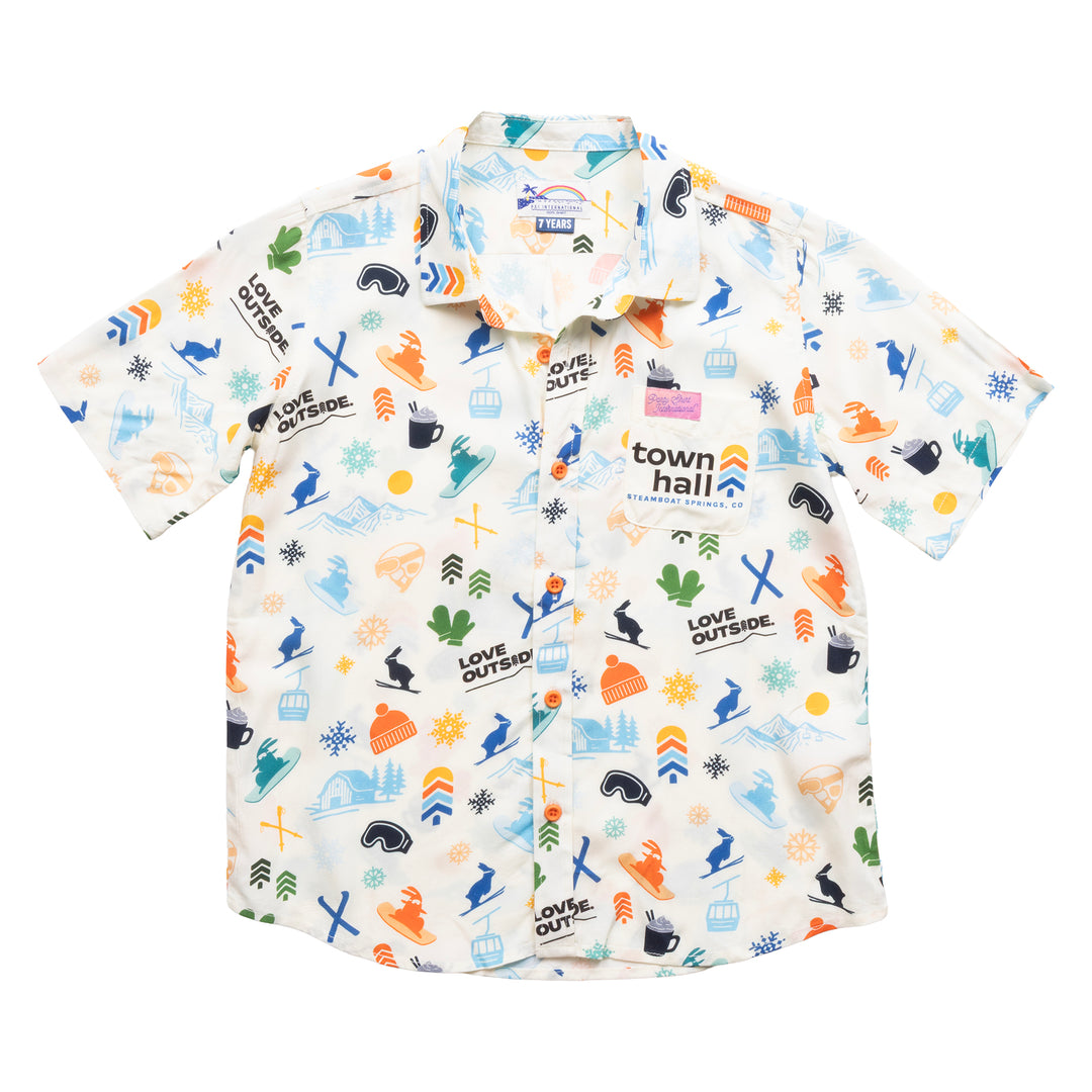 Front view of Town Hall Kids Cabana Shirt in Vanilla with ski-town print, orange buttons and a logo chest pocket.
